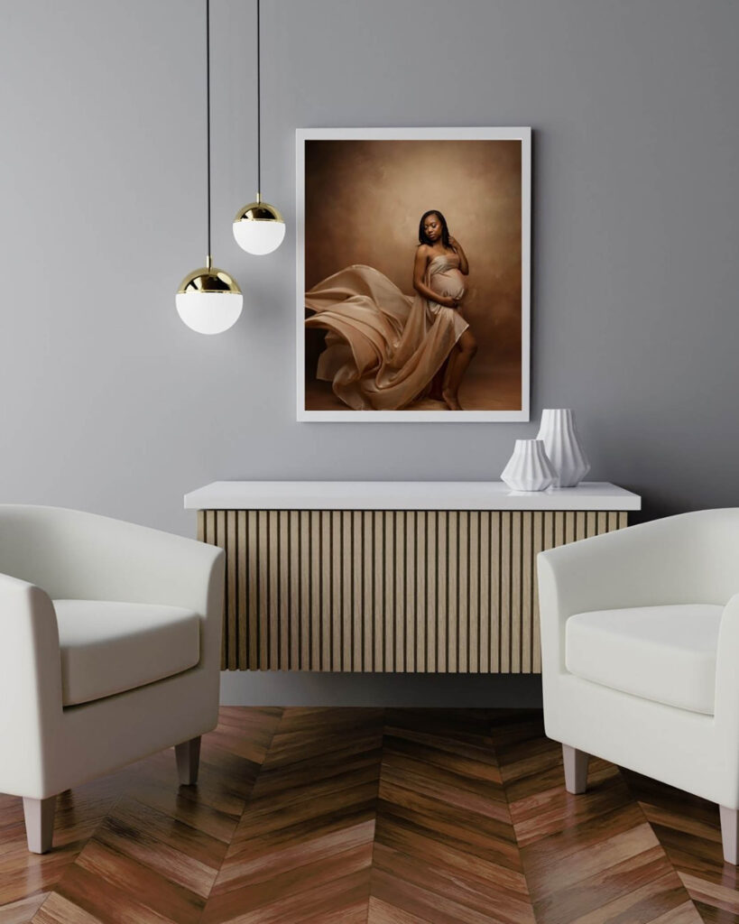 Modern living room with white chairs, wooden sideboard, pendant lights, and maternity photo on gray wall.